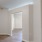 a room with light colored walls and wood-style flooring