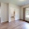 a room with a large window and wood-style flooring